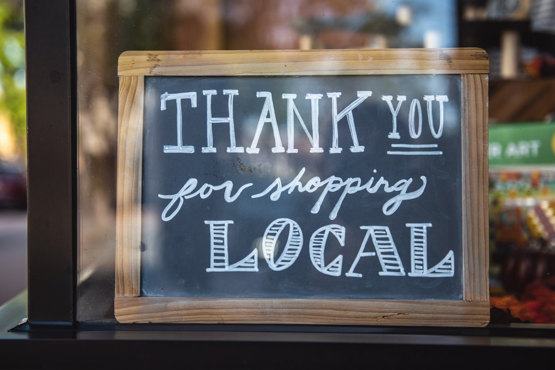 A sign thanks customers for shopping local.